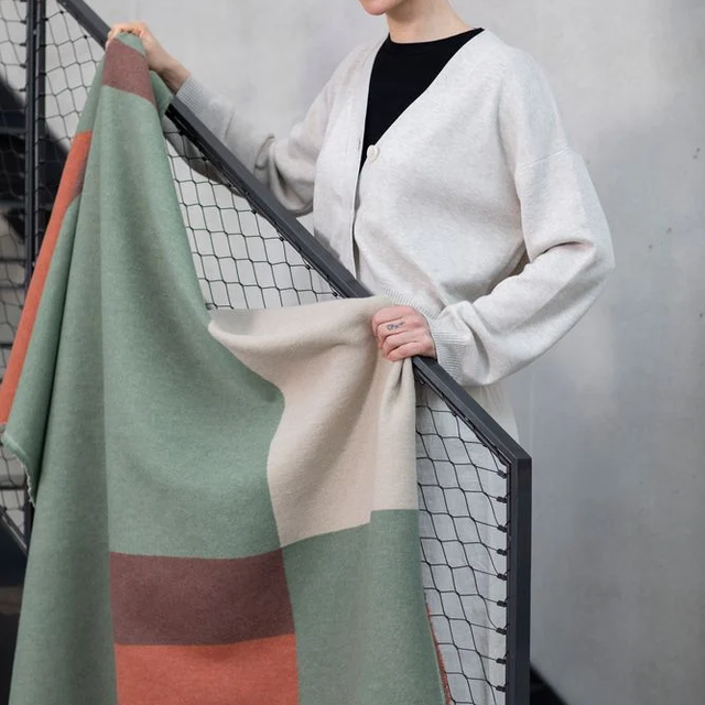 LUCA Throw "Squares" green — draped, showing the reverse