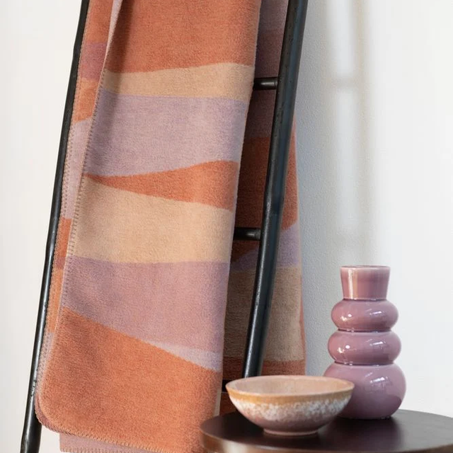 SAVONA Throw "Geometric Shapes" copper — draped on a ladder rack