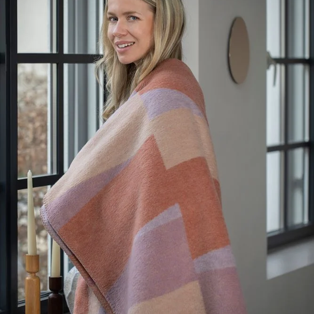 SAVONA Throw "Geometric Shapes" copper — shown around the shoulders for scale